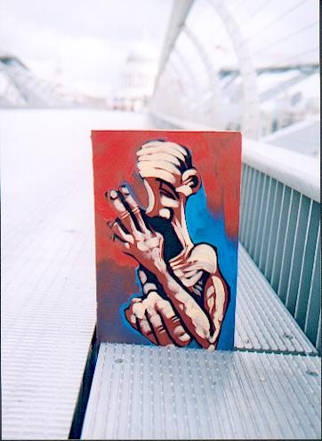 Adam Neate painting on a bridge