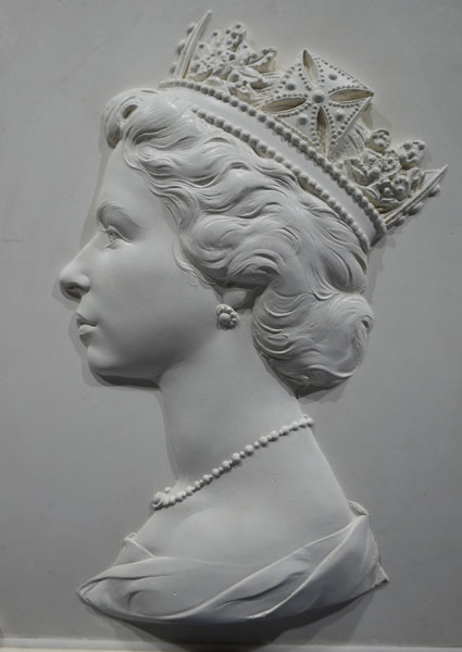 Queens stamp head sculpture