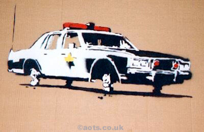 Banksy cop car on bricks