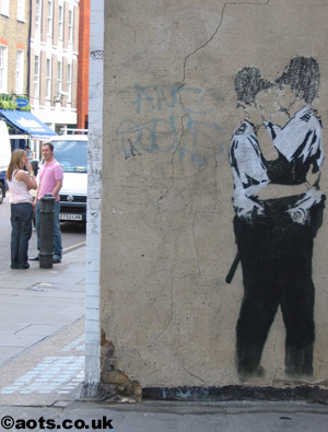 Banksy kissing coppers buffed