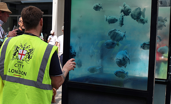 Photo of City of London and the Banksy Pirahna fish tank in a Police Call box