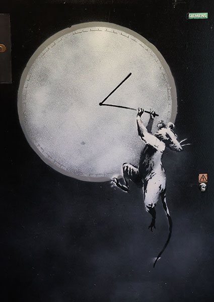 A close up of the Banksy rat hanging off a clock at the GDP store.