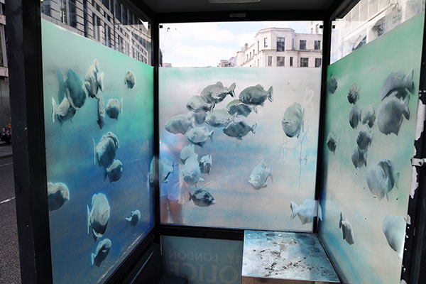Banksy Piranha fish tank in a City of London Police call box