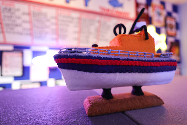 photo of the RNLI donations lifeboat on the counter at Lucy Sparrow's chippy