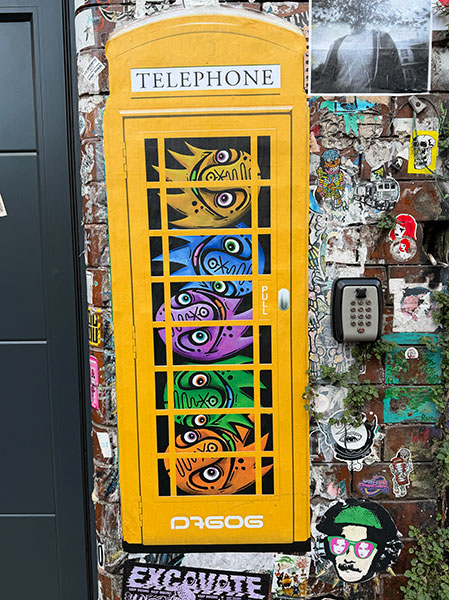 D7606 yellow phone box paste up in Shoreditch